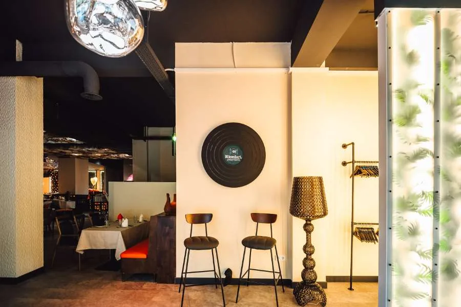 Bar area with the RioniArt vinyl-record logo mounted on the wall